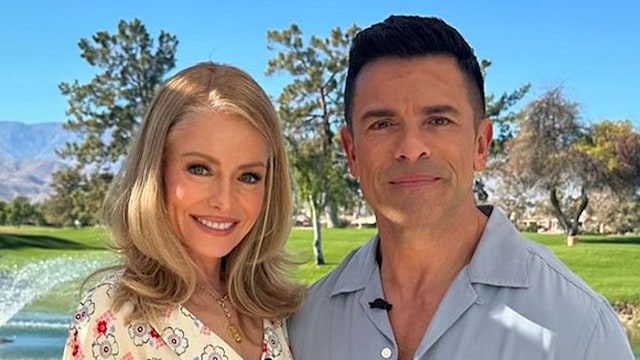 Kelly Ripa wears white floral dress while posing with Mark Consuelos in front of lake