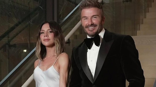 David and Victoria Beckham pose on the stairs