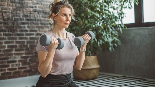Women working out at home in a light tshirt