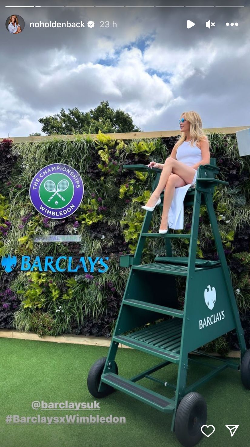 Amanda poses in an umpire's chair