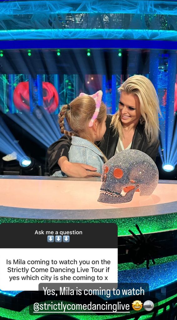 Nadiya Bychkova and a young girl at a desk with a glittery skull on it