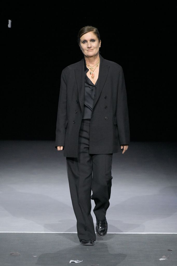 Maria Grazia Chiuri  in black outfit on runway