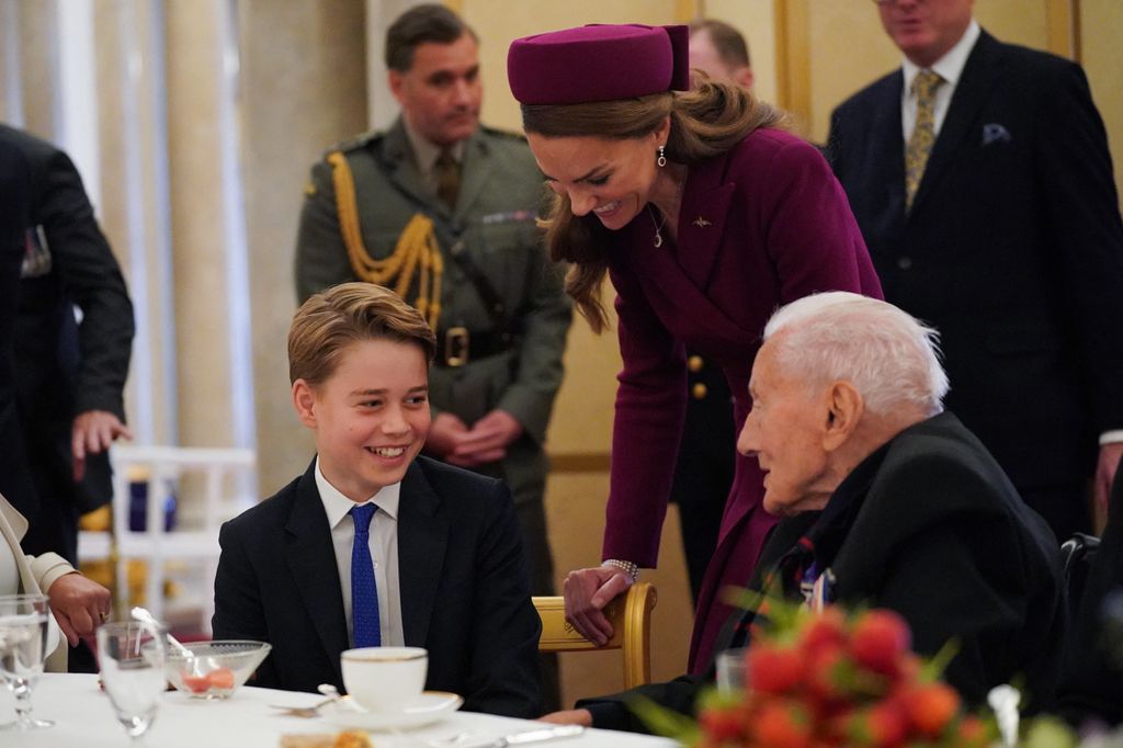 Prince George of Wales (L) and Britain's Catherine, Princess of Wales (C) speak with a Second World War veteran during a tea party at Buckingham Palac