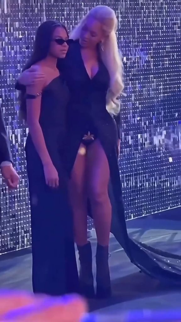 Beyonce with her arm around Blue Ivy