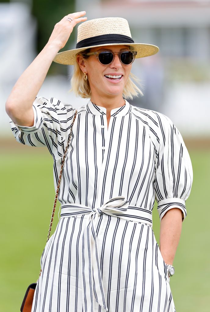 zara tindall smiling in striped dress and boater hat