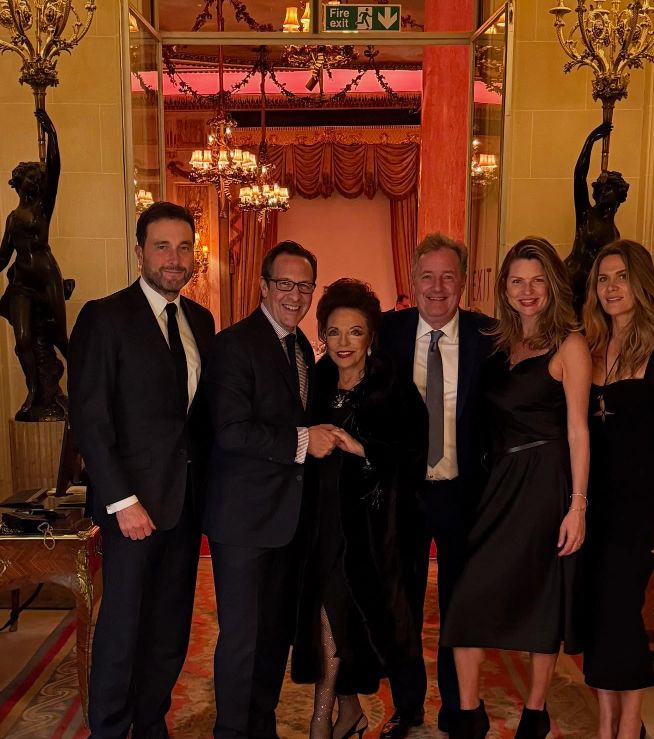Three men and three women standing in a line at the Ritz