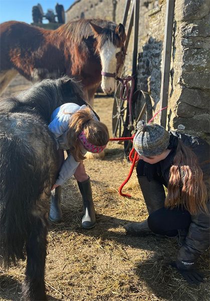 Two children with two horses