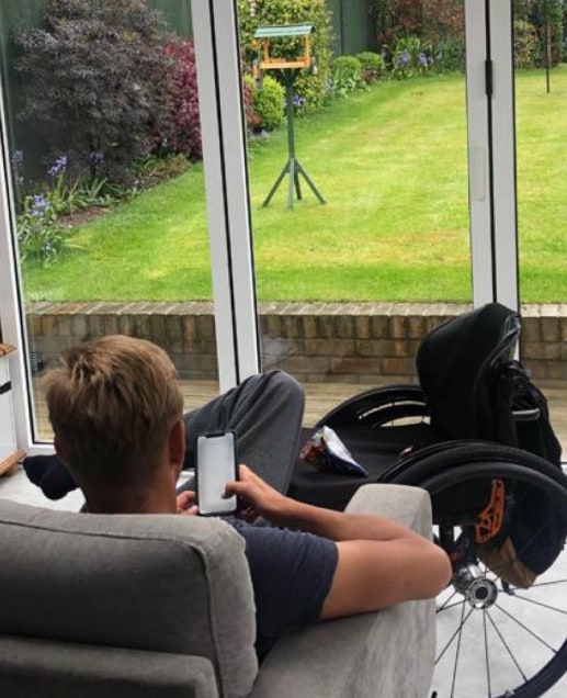man on sofa looking out to garden