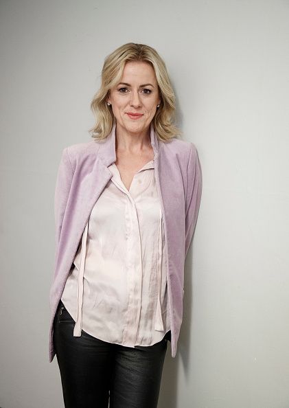 Jojo Moyes in a silky shirt and a purple blazer