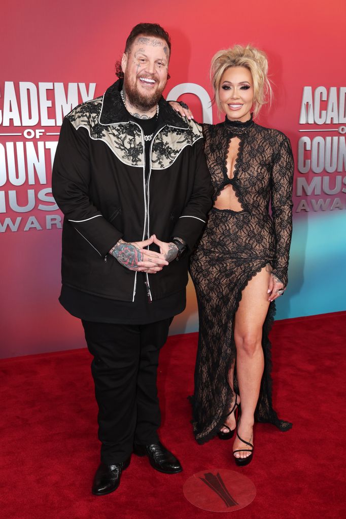 jelly roll and bunnie xo posing together acm awards
