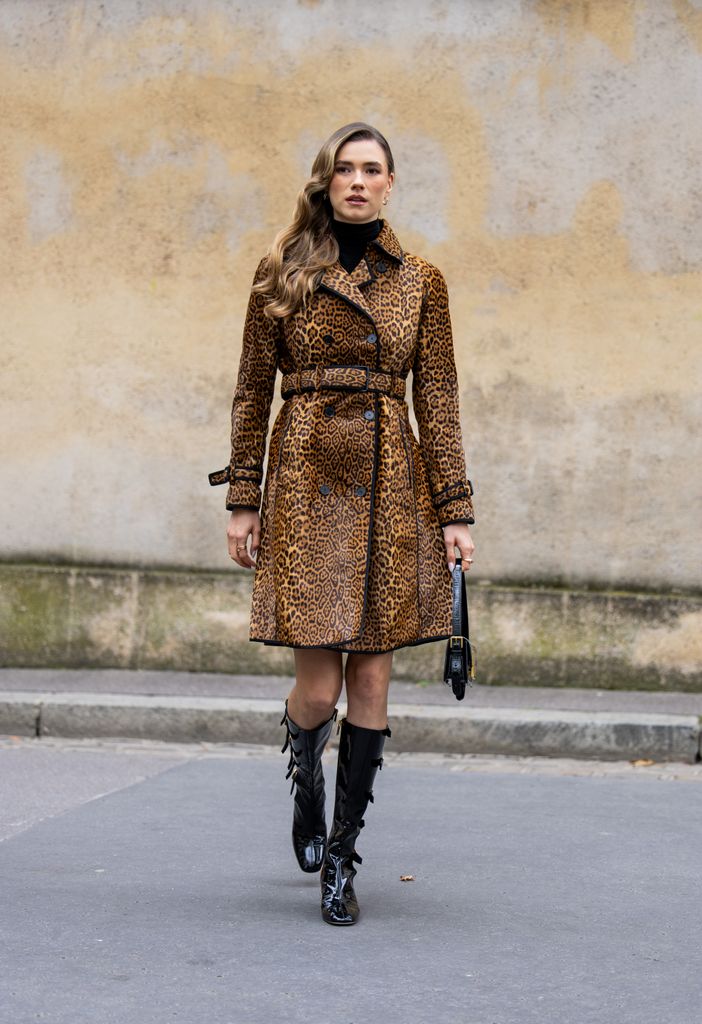 Zita d'Hauteville wears leopard print coat, black bag, boots outside Dior during Womenswear Spring/Summer 2025 as part of  Paris Fashion Week on September 24, 2024 in Paris, France. 