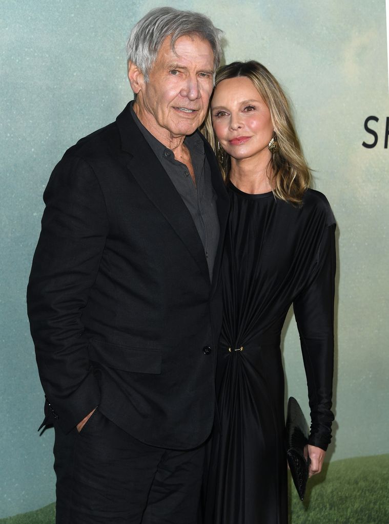 Harrison Ford and Calista Flockhart wearing black smart evening wear standing side by side at the premiere for Apple TV+ Shrinking