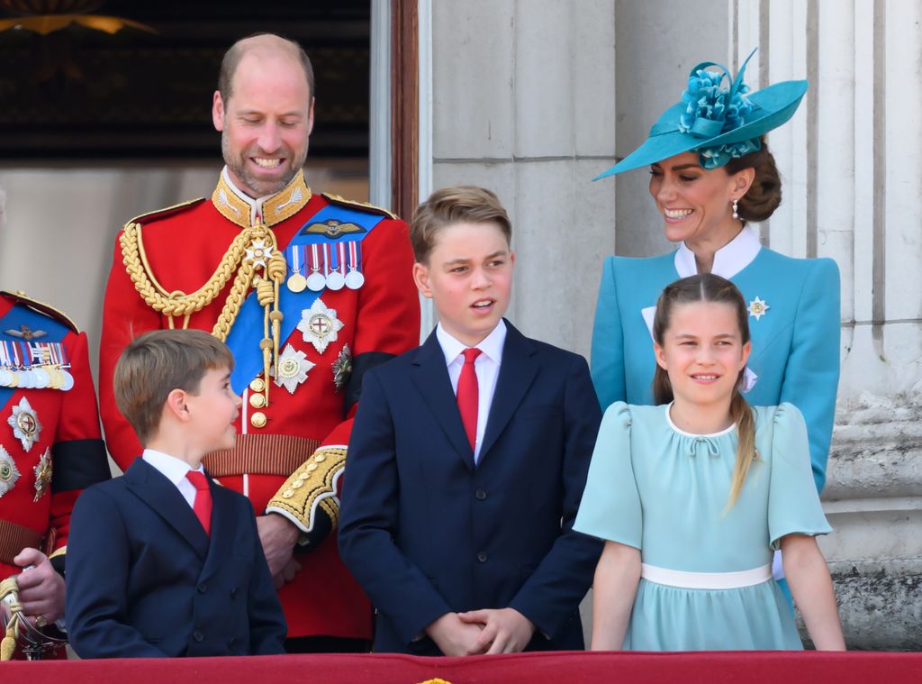 Louis and Kate smiling at each other on palace balcony