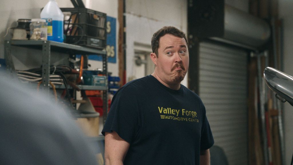 man in car workshop