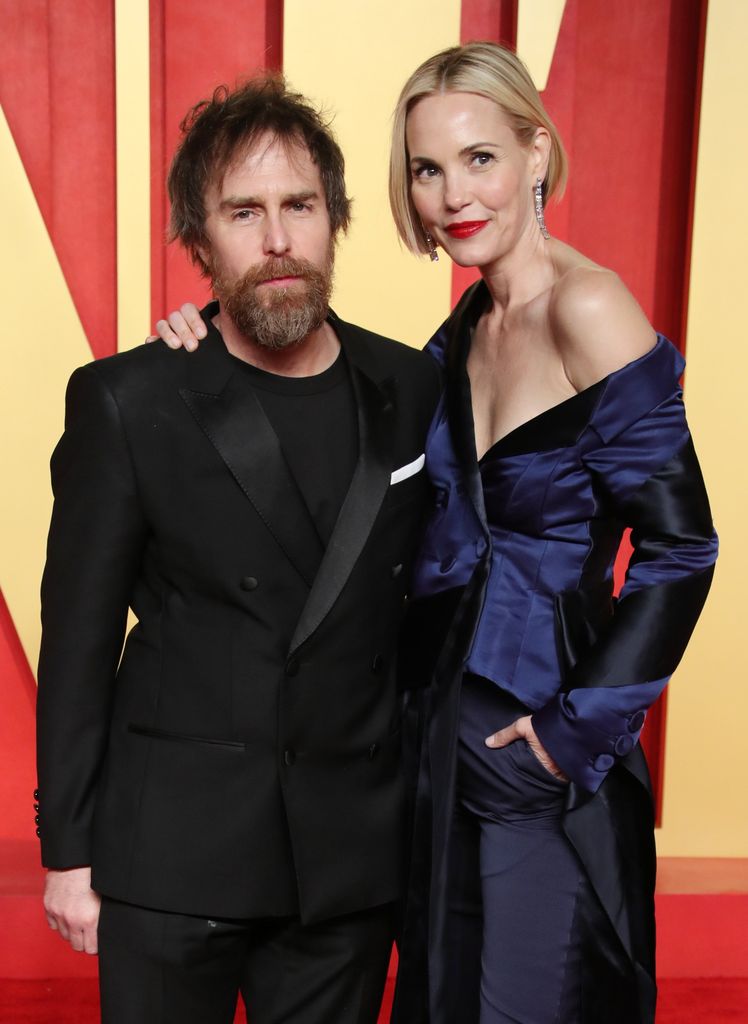 Man and woman posing on red carpet