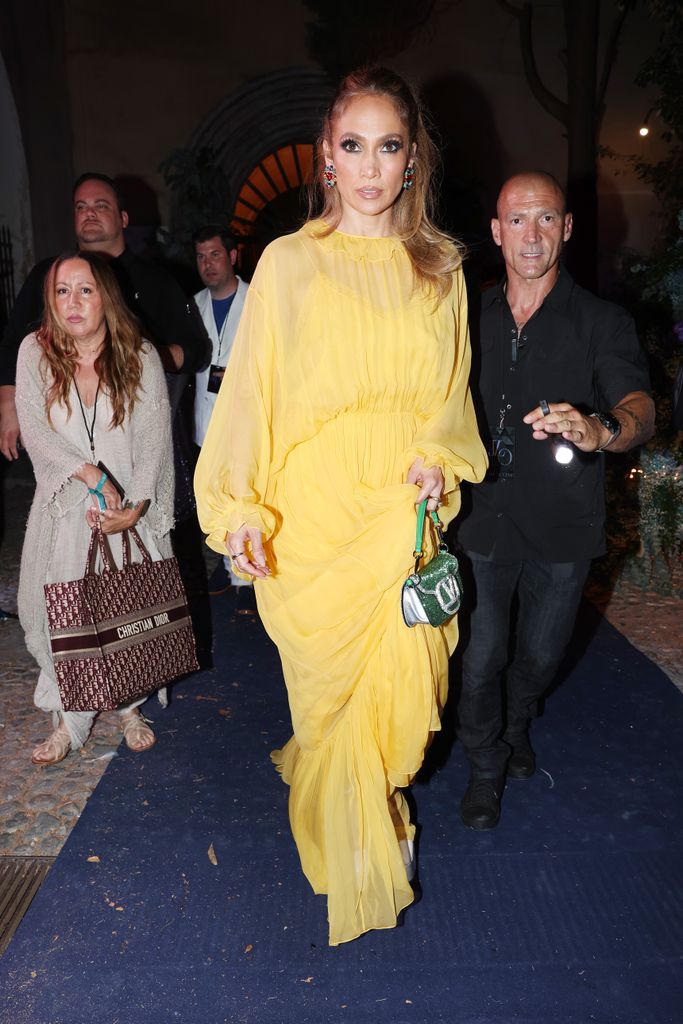 JLo walking in yellow dress