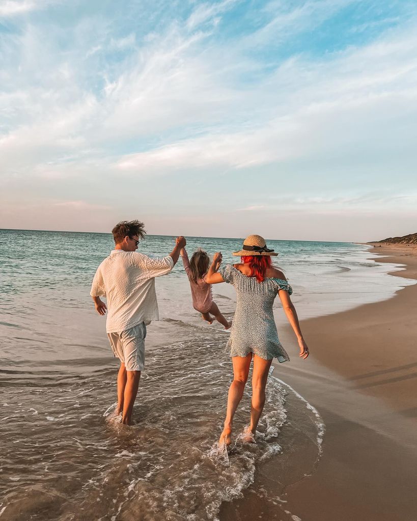 couple on beach with little girl 