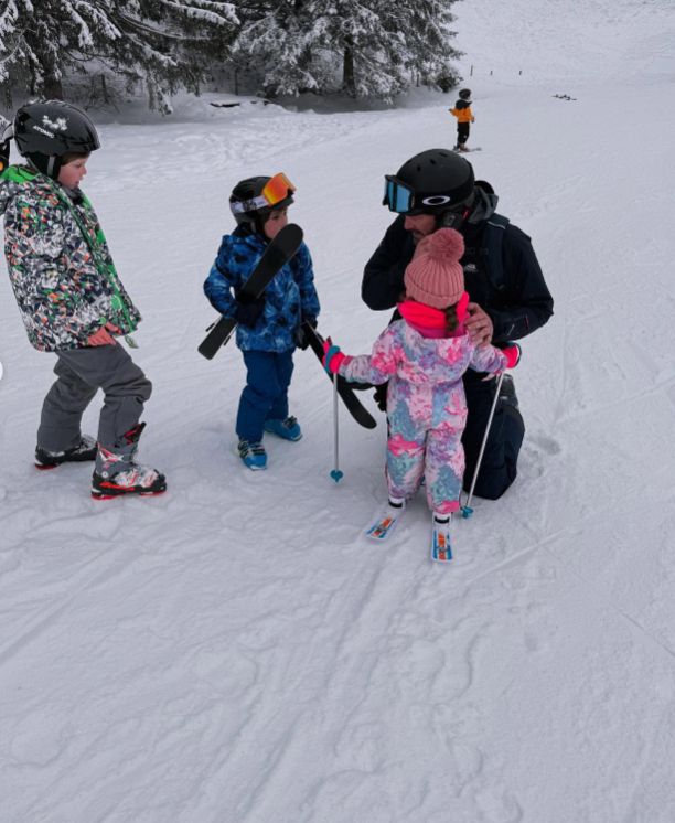 Charlie Thomson and three children in ski outfits