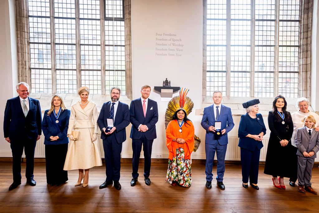 Queen Maxima standing in line up of people