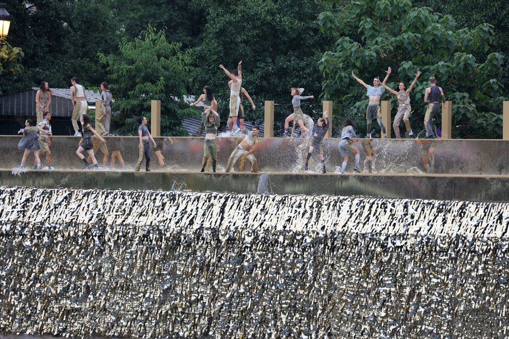 Dancers perform on the banks of the river Seine during the opening ceremony of the Paris 2024 Olympic Games