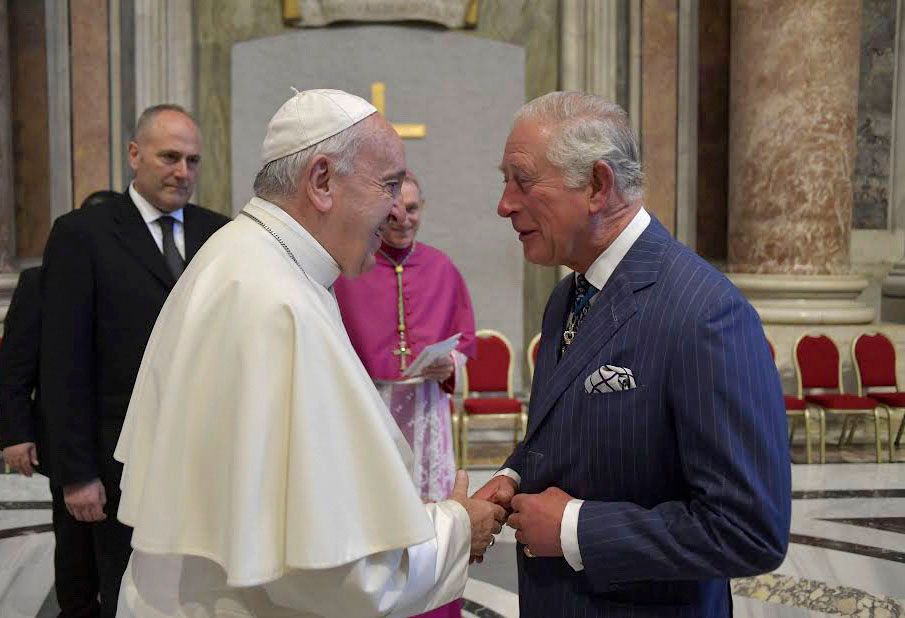 Pope Francis shaking hands with King Charles