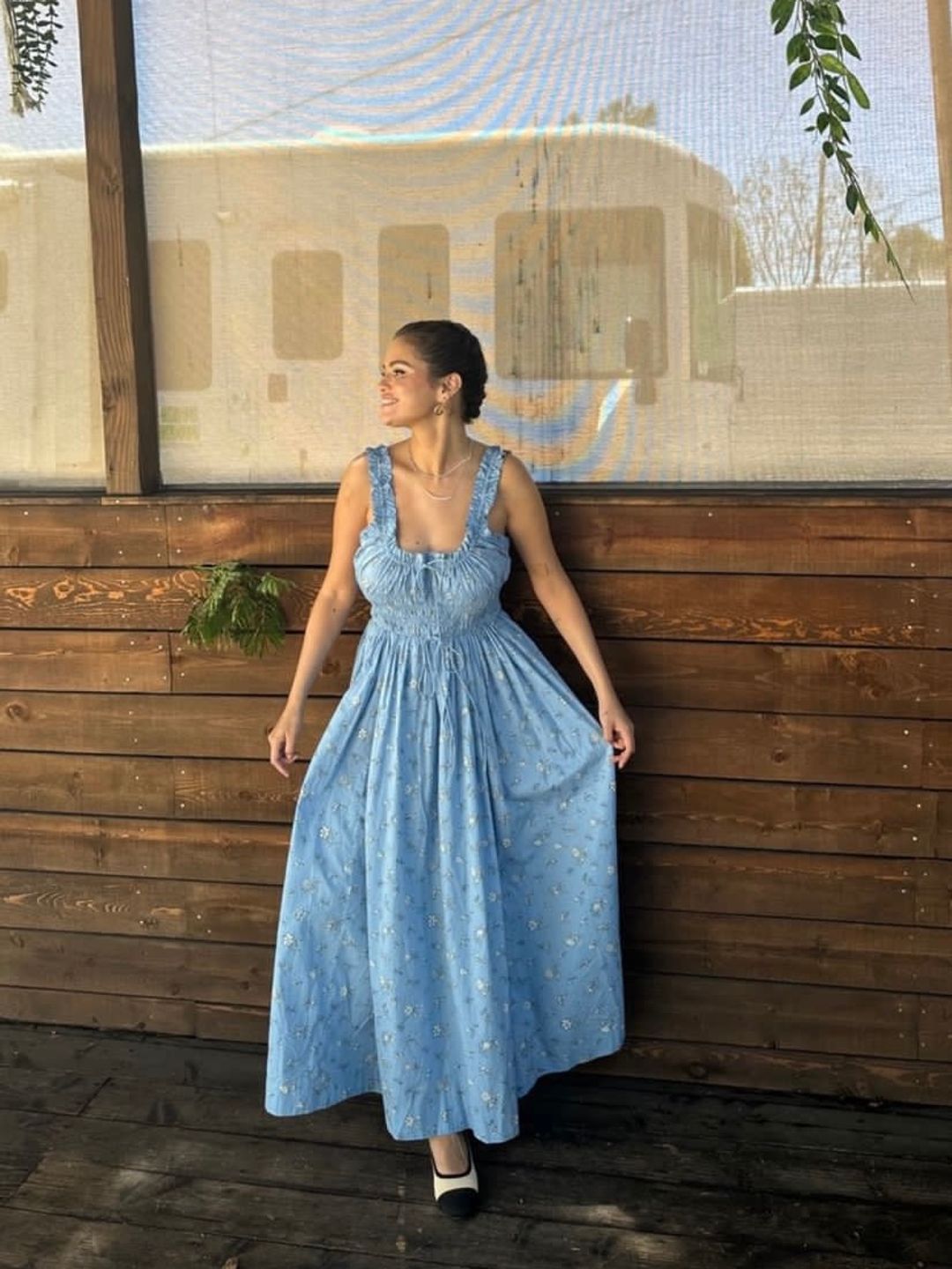 Selena Gomez wearing a pretty, shirred maxi with a braided updo 