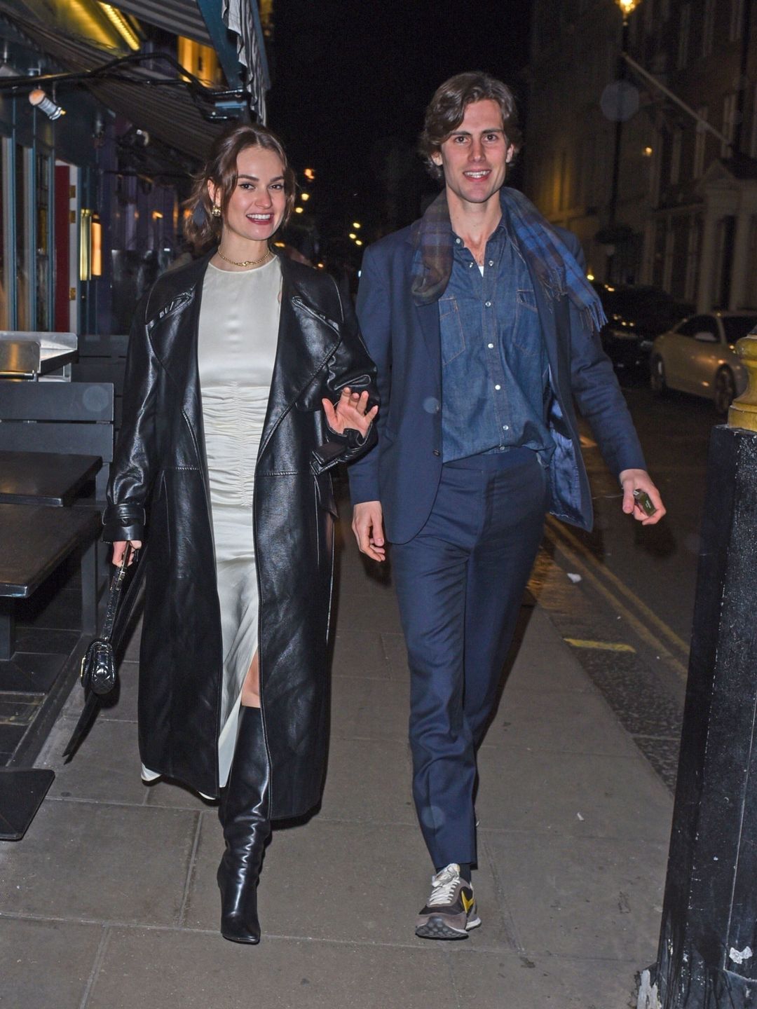  Lily James rocks a Mango satin midi alongside a leather maxi coat