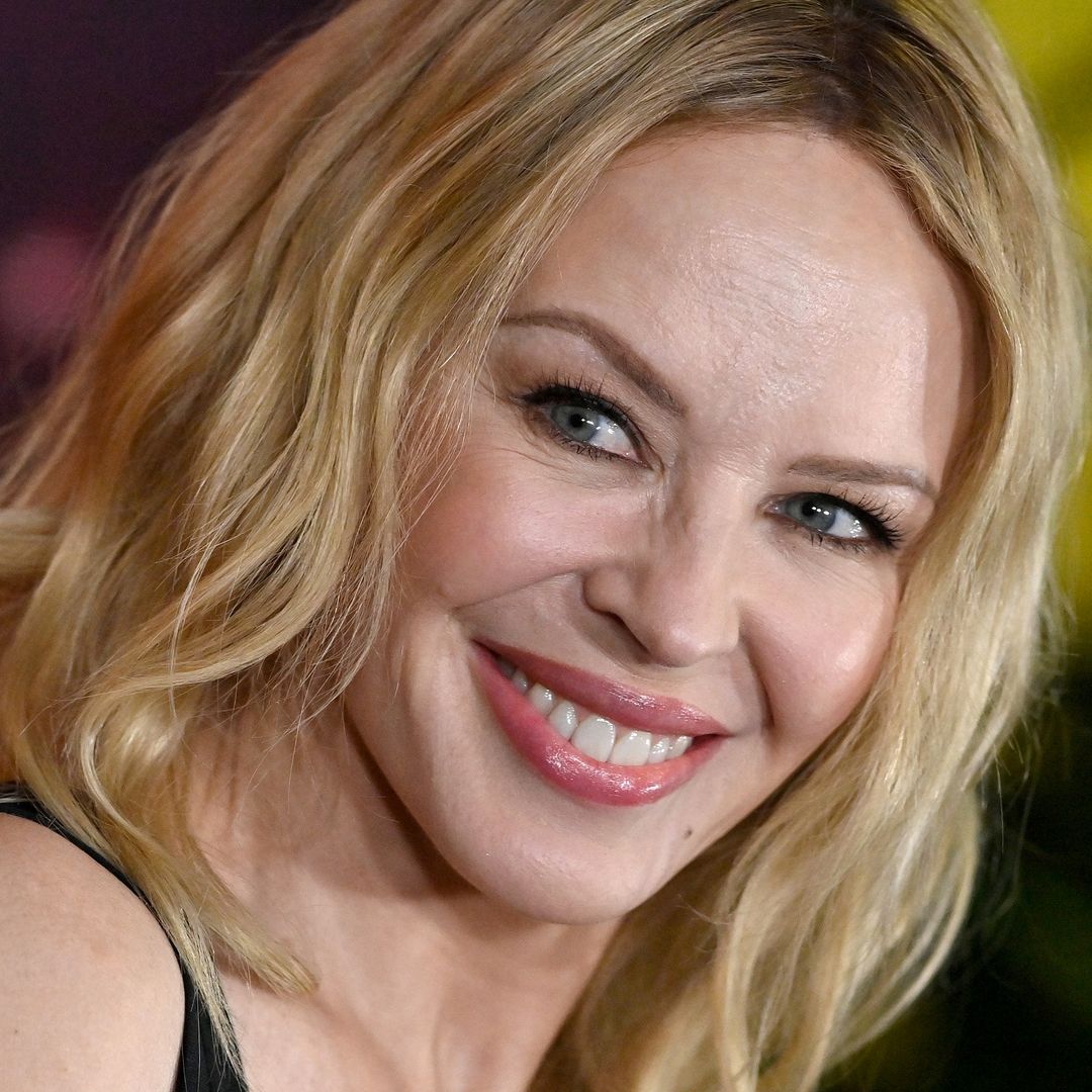 Kylie Minogue is a vixen in sheer dress and daring knee-high boots