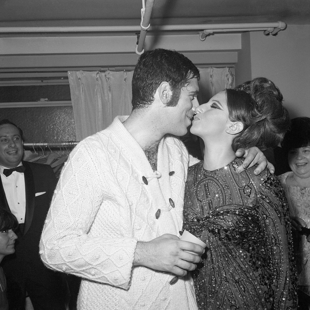 10/11/1965-New York, NY- Barbra Streisand, star of Broadway's "Funny Girl," gives her husband, Elliott Gould, a congratulatory kiss after his opening October 10th in the musical comedy, "Drat! The Cat!"